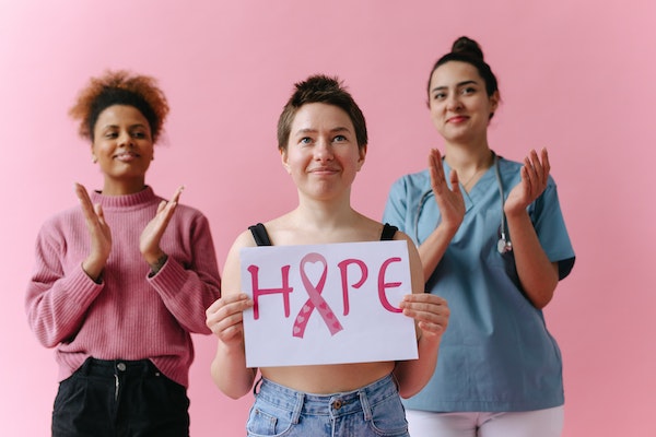 deux femmes soutenant une personne atteinte du cancer du sein